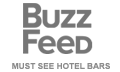 This image features the BuzzFeed logo with the text "MUST SEE HOTEL BARS" underneath it, all in a gray color. logo on footer section.